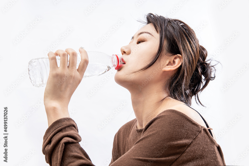Girls drink plenty of water to replenish body fluids after exercise Girls drink plenty of water to replenish body fluids after exercise