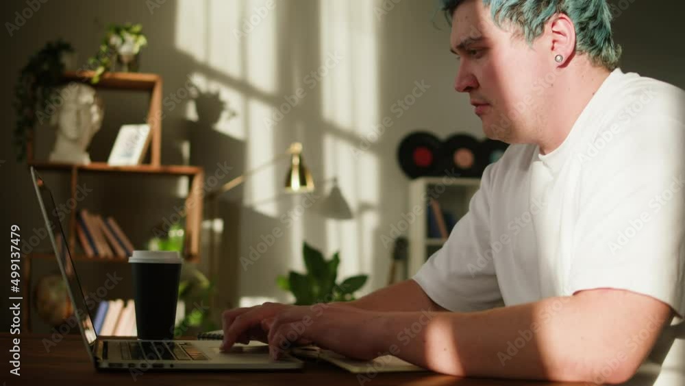 Typing on laptop keyboard close-up. Man with blue hair working in office, writing notes. Businessman texting on computer, copywriter. Typing on laptop keyboard close-up. Man with blue hair working in office, writing notes. Businessman texting on computer, copywriter.