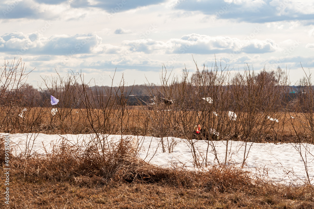 Environmental pollution. Garbage in nature. Spring fields and bushes are littered with garbage - plastic bags. Environmental pollution. Garbage in nature. Spring fields and bushes are littered with garbage - plastic bags.