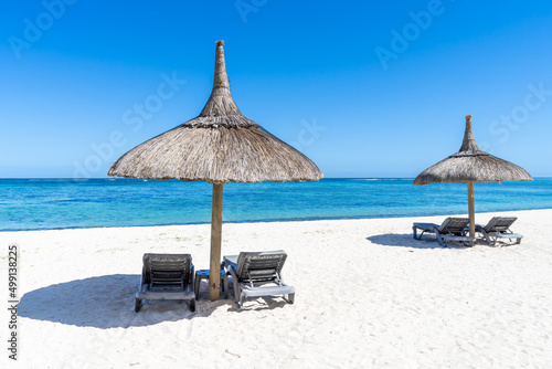 Fototapeta Naklejka Na Ścianę i Meble -  Summer vacation on the beach with beach chair and sunshade