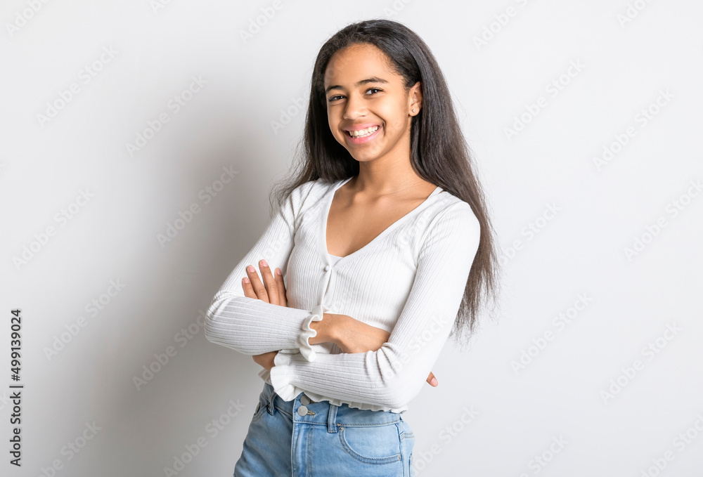Beautiful black teen posing on studio white background with arm cross