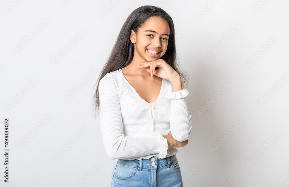 Beautiful black teen posing on studio white background Beautiful black teen posing on studio white background