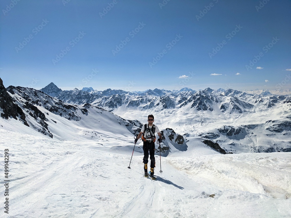 Man on a ski tour in a wonderful mountain landscape. Freedom and pure passion for ski mountaineering. Above the Fluelatal on the Gorihorn