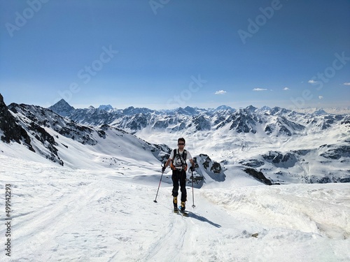 Man on a ski tour in a wonderful mountain landscape. Freedom and pure passion for ski mountaineering. Above the Fluelatal on the Gorihorn