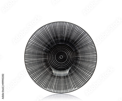 Plate on a white isolated background. View from above. Small flat round plate.