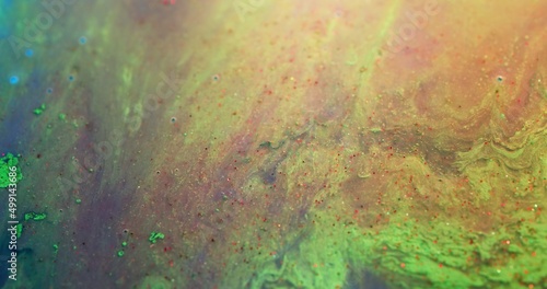 Floating paint. Ink water texture. Acrylic mixture. Epoxy resin. Defocused green red color dye with grain bubble surface abstract art background.
