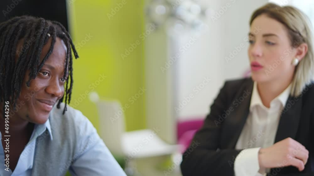 Pan shot closeup of a young multiethnic diverse couple sitting at the desk talking to a doctor, an analyst, or a chief during a meeting at work or a consultant.
Pan shot closeup of a young multiethnic diverse couple sitting at the desk talking to a doctor, an analyst, or a chief during a meeting at work or a consultant.