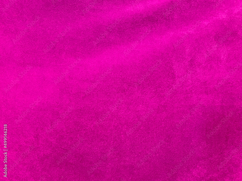 Pink velvet fabric texture used as background. Empty pink fabric