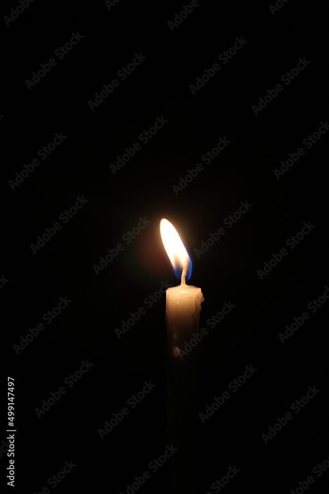 Closeup shot of candle light in the darkness Closeup shot of candle light in the darkness