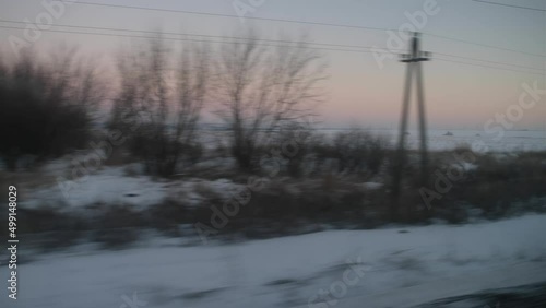 View from the train window on the evening winter landscape, long journey, snowy expanses