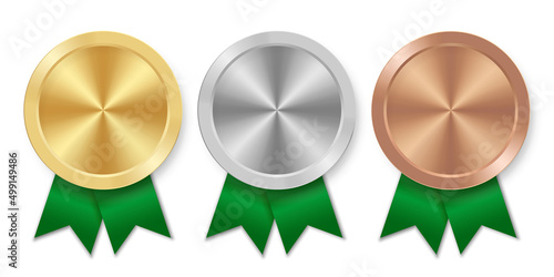 Golden silver and bronze award sport medal with green ribbons