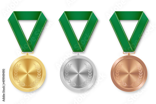 Golden silver and bronze award sport medal with green ribbons