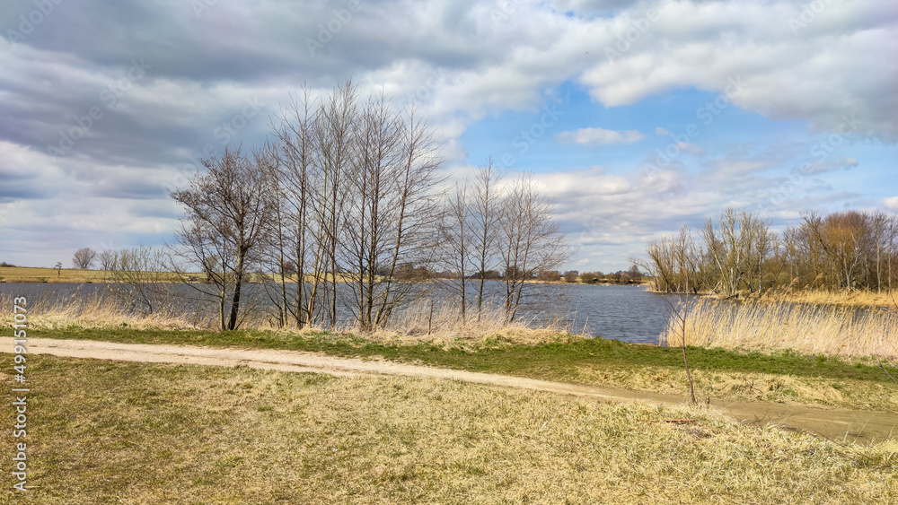 Wild lake landscape with trees and perfect cloudy sky Wild lake landscape with trees and perfect cloudy sky
