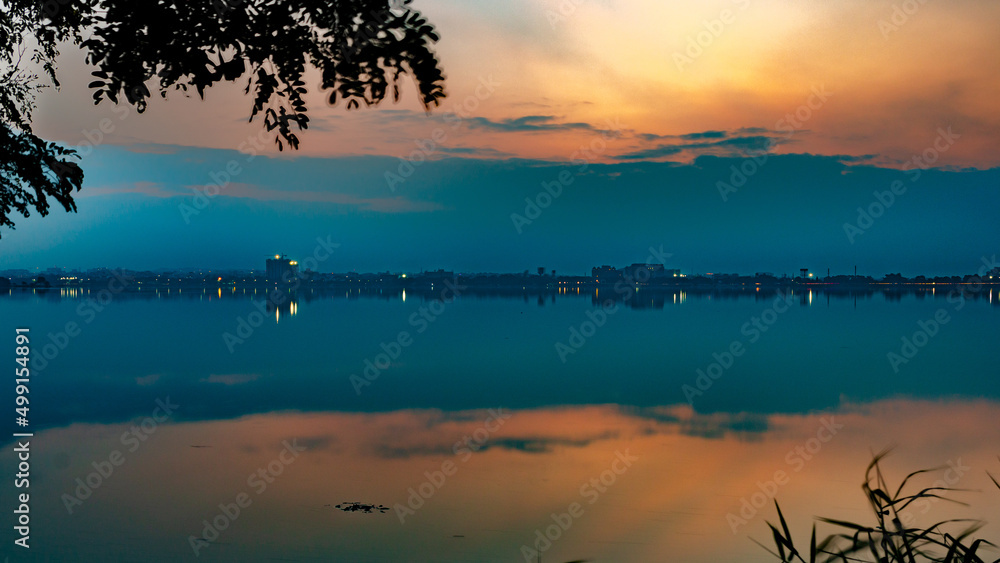 Sunset with a beautiful sky in the golden hour at Hussain Sagar Lake in Hyderabad, Telangana, India