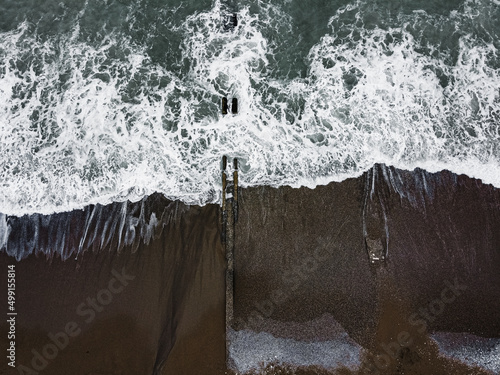 Aerial drone photo of sea beach with wave splash cloudy weather after before the storm island beach (ID: 499155814)