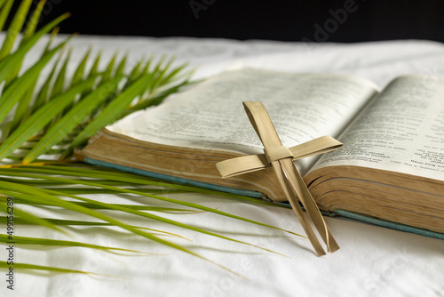 cross made from palm leaf with bible and palm leaves