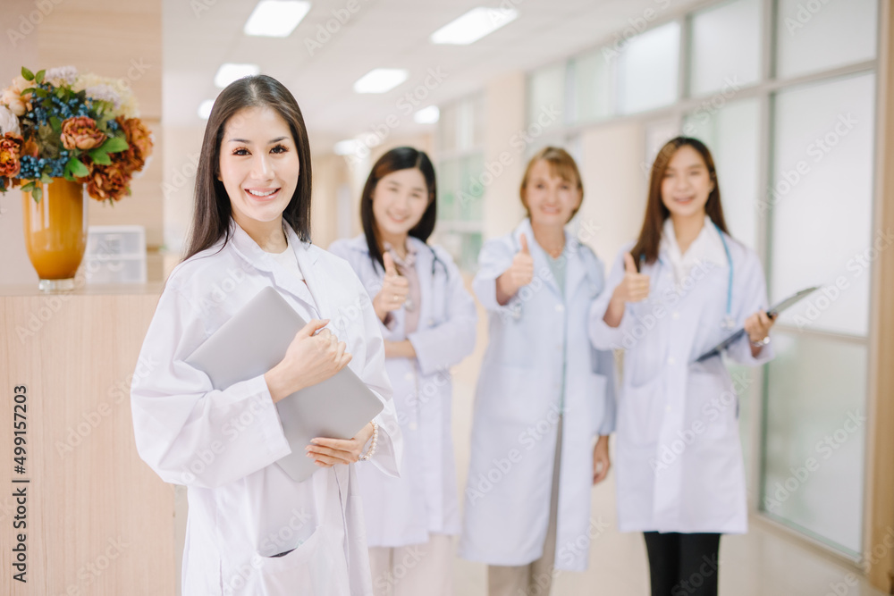 A group of medical professionals put their thumbs up and looked very straight at the camera with a friendly gesture. A group of medical professionals put their thumbs up and looked very straight at the camera with a friendly gesture.
