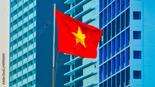 The national flag of Vietnam. Flag on the central square of Nha Trang against the backdrop of high-rise hotels. 