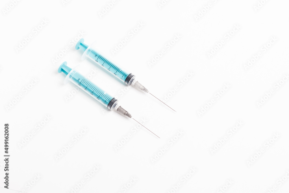 Fototapeta premium Medical syringe on a white background. A syringe for injection. The concept of health and beauty