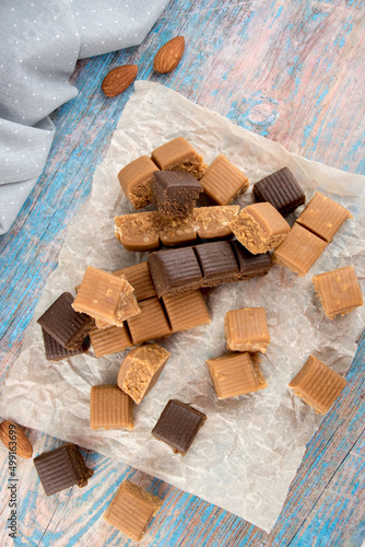 Chocolate caramel lies beautifully in pieces. Sweet toffee with nuts and cocoa