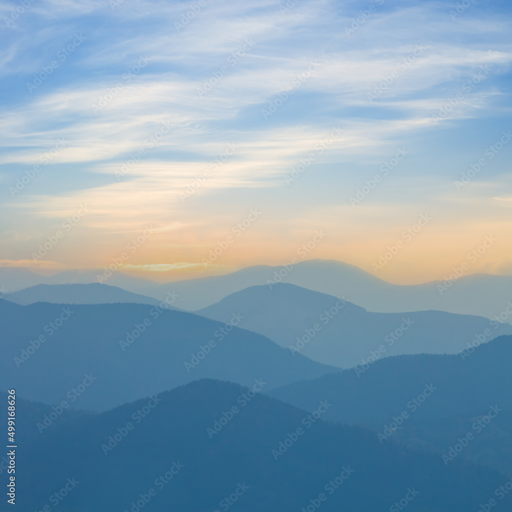 mountain chain silhouette in blue mist at the early morning,  beautiful outdoor travel background