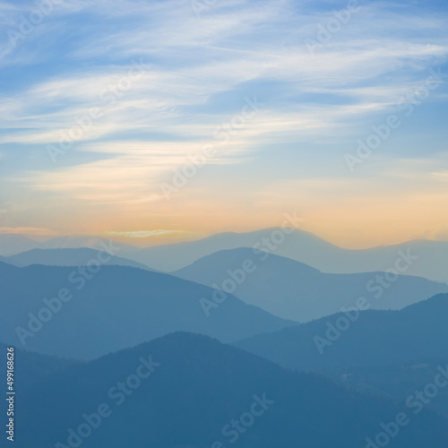 mountain chain silhouette in blue mist at the early morning, beautiful outdoor travel background