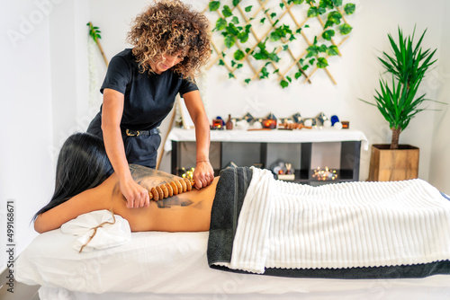 masseuse doing a wood therapy massage