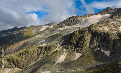 mountain ridge with glacier in dense clouds