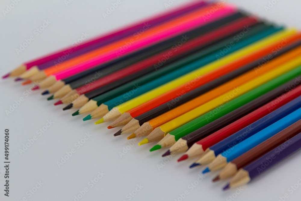 a row of coloured pencils on white background horizontal a row of coloured pencils on white background horizontal
