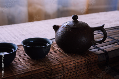 tea set on a table with a bamboo mat