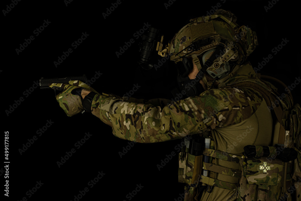 SOF special forces soldier wearing US made gear, crye precision, ops core. Studio portrait  isolated on black background 