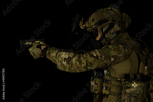 SOF special forces soldier wearing US made gear, crye precision, ops core. Studio portrait  isolated on black background  photo