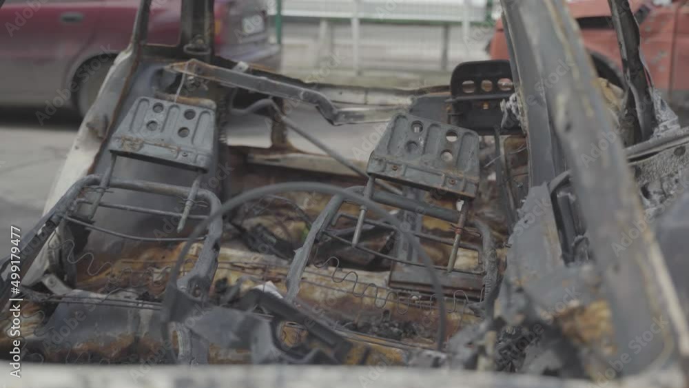 Burnt cars in a parking lot near residential buildings after the city was bombed. Ukraine. Kyiv. District Troieshchyna Burnt cars in a parking lot near residential buildings after the city was bombed. Ukraine. Kyiv. District Troieshchyna