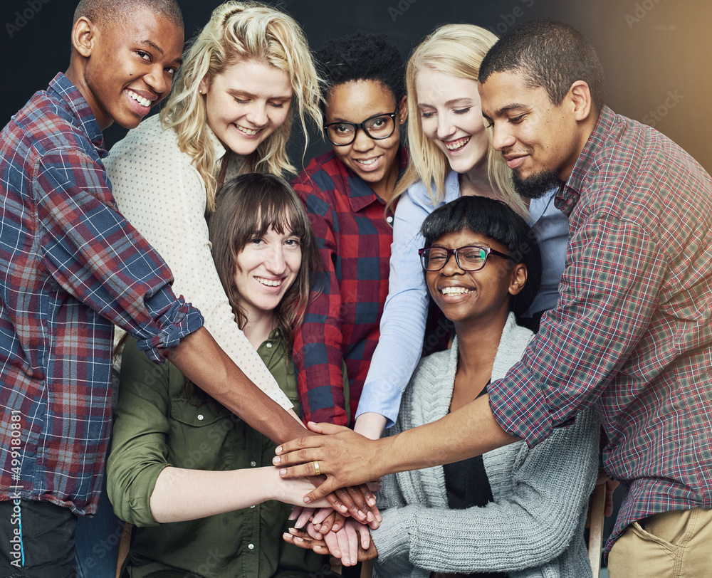 Fototapeta premium Heres to positive partnerships. Shot of a group of people putting their hands together.