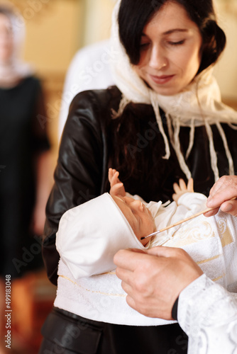 baptism of a child in the church. Ukrainian Orthodox Church. Orthodox baptism of a child. Church rite of acceptance of faith. The priest baptizes the baby