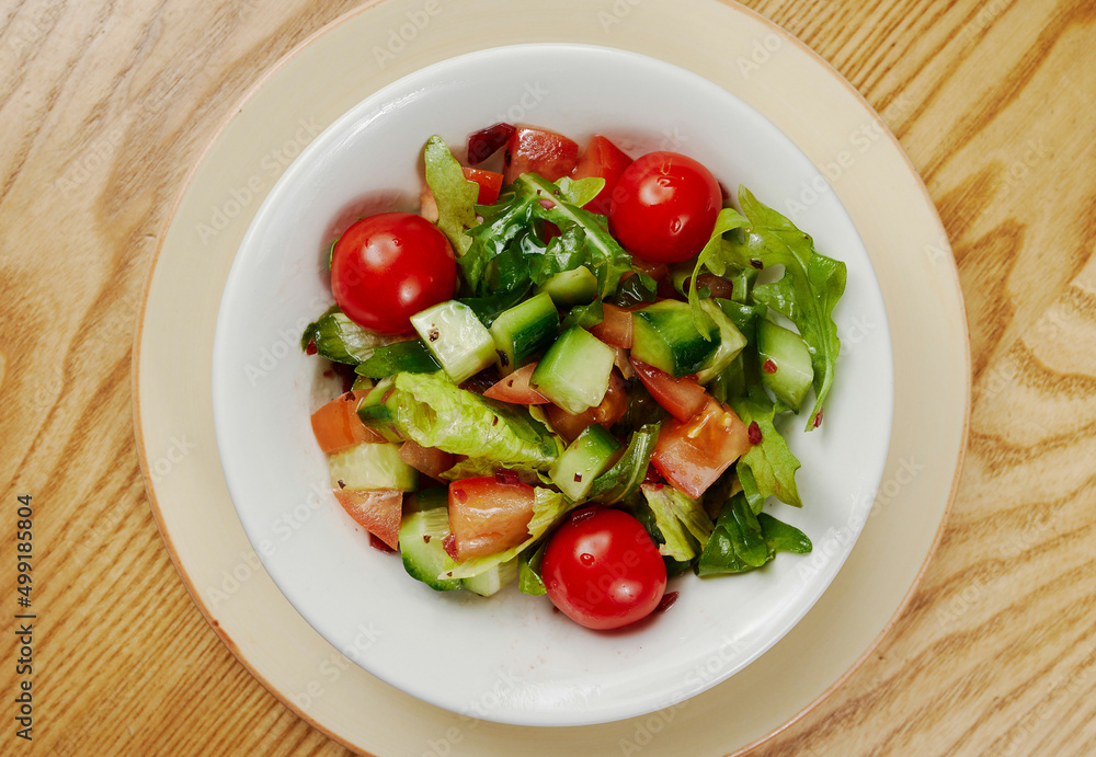Light vegetable salad with cucumbers, lettuce, cucumbers