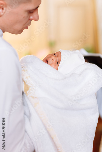 baptism of a child in the church. Ukrainian Orthodox Church. Orthodox baptism of a child. Church rite of acceptance of faith. The priest baptizes the baby © Anhelina Tyshkovets