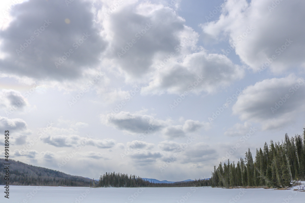 Fototapeta premium Frozen lake in Canadian rocky mountains during winter