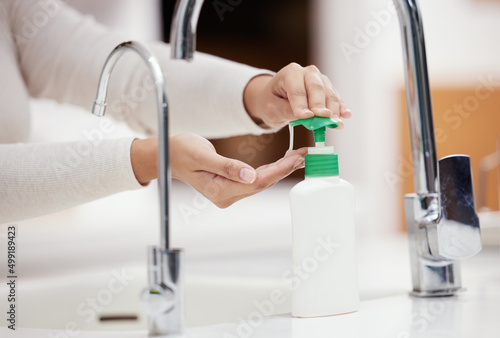 Dont forget to use soap. Shot of an unrecognizable person washing her hands with soap at home. © Beaunitta V W/peopleimages.com