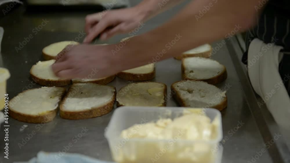 Closeup of Hands Preparing Sandwiches in a Restaurant Kitchen