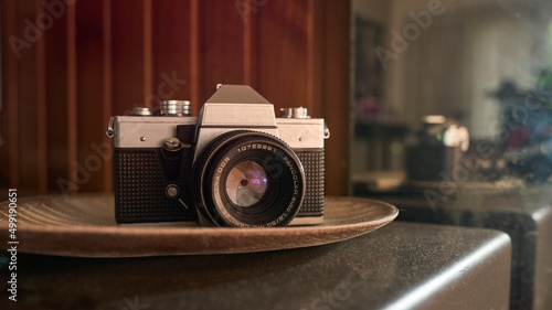 Wallpaper Mural Vintage camera on a brown table and behind a reflection of it Torontodigital.ca