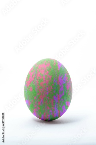 Egg standing upright on a white background. Closeup of egg shell texture.