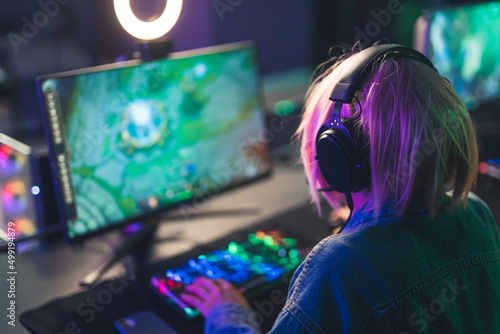 girl playing video game in computer cyber sport concept medium closeup neon lights indoors . High quality photo