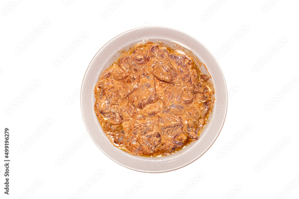 Pork meat in barbecue sauce.Pork kebab in marinade on a plate.Pork meat in marinade on a white background. Pork meat in barbecue sauce.Pork kebab in marinade on a plate.Pork meat in marinade on a white background.