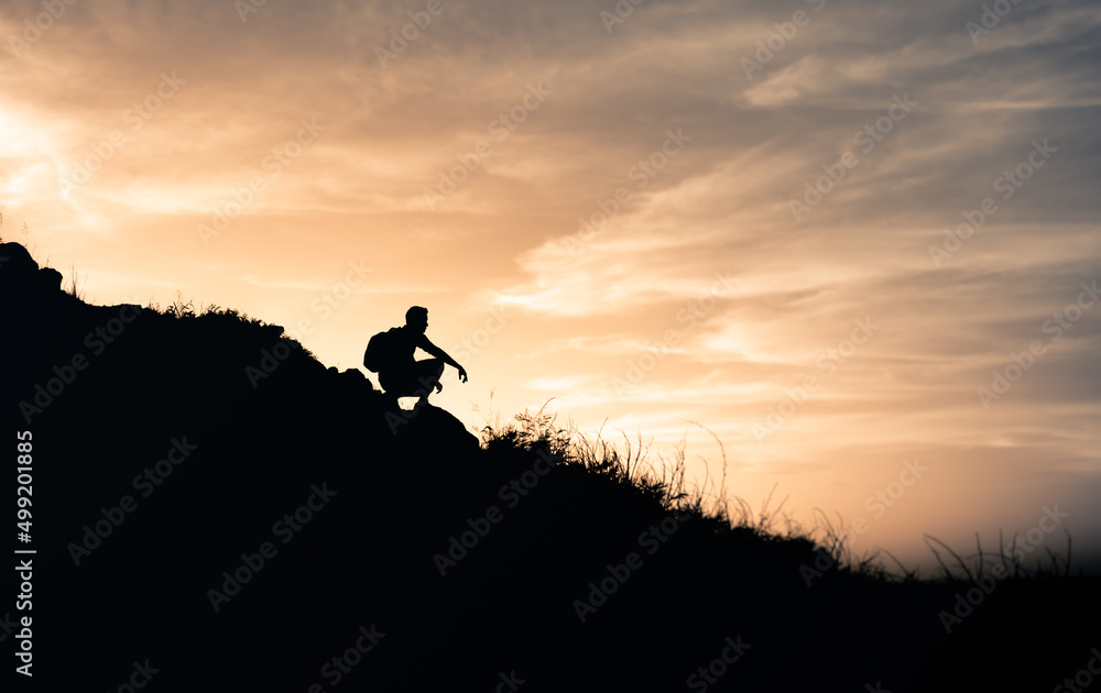 Man on the edge of mountain looking out at the view