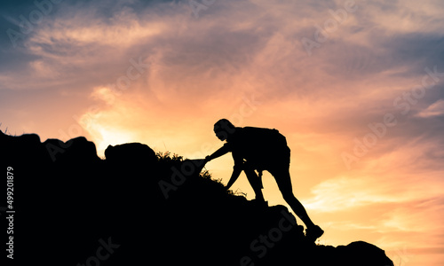 Never give up, goal setting concept. Man combing mountain cliff. 