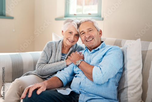 Filling the golden years with lots of love. Shot of a senior couple relaxing together on the sofa at home.