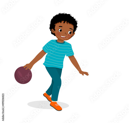 cute little African boy playing bowling in the sport club ready to throw the ball
