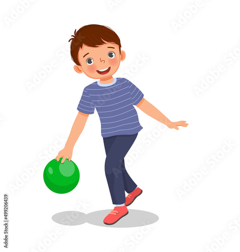 cute little boy playing bowling in the sport club ready to throw the ball