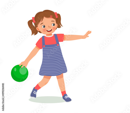 cute little girl playing bowling in the sport club ready to throw the ball